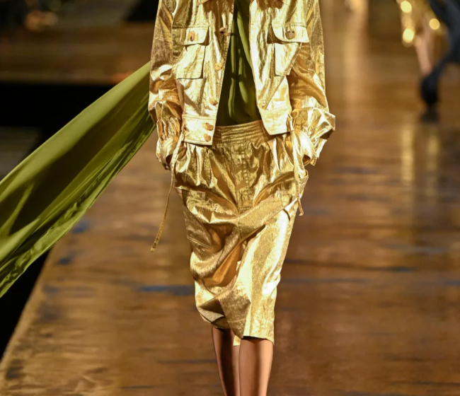 Model wearing a gold Saint Laurent Spring 2027 runway look during Paris Fashion Week.